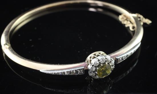 A late Victorian gold and silver, zircon? and diamond cluster hinged bangle,